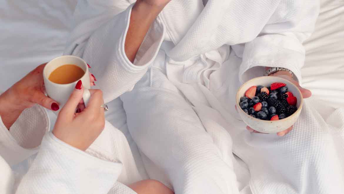 Guests sipping coffee and eating berries.
